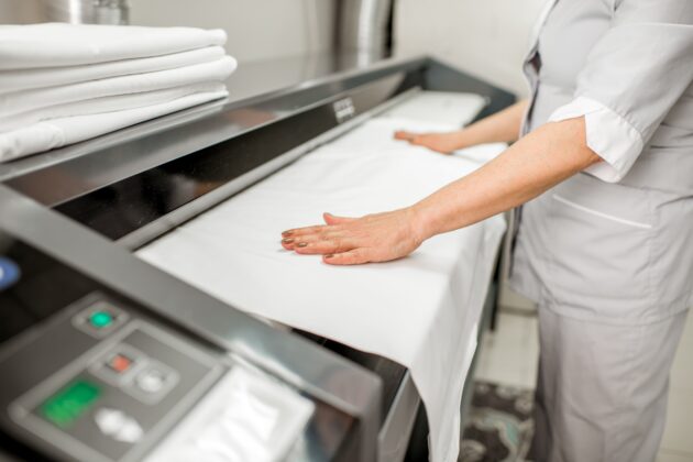 Improve hotel laundry operations with a commercial ironer